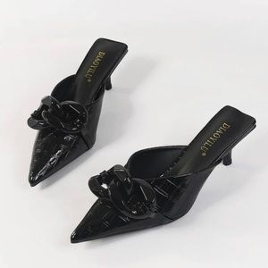 Black heels. PU Leather  outsole material is  rubber.